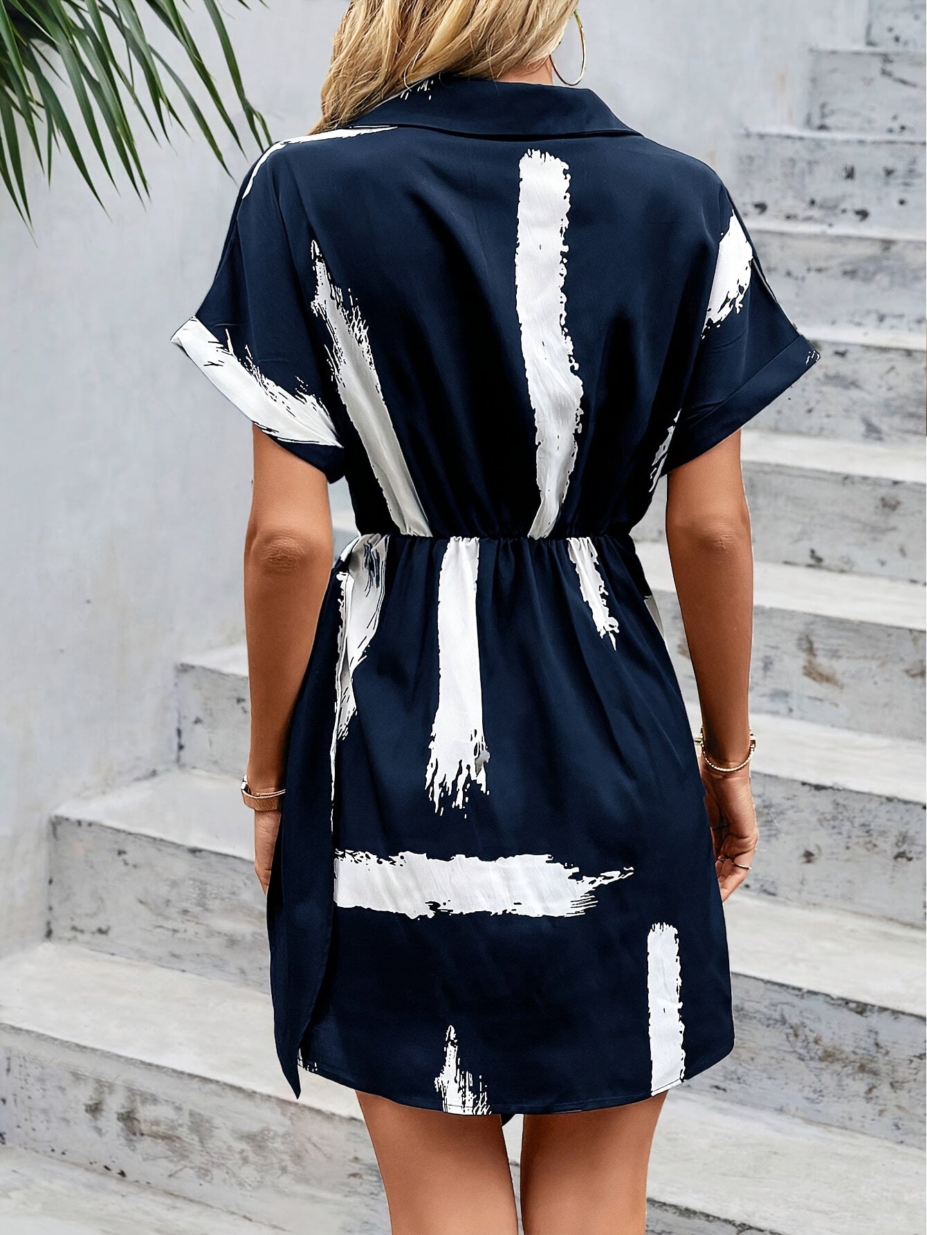 Dunkelblaues Kleid mit Bindegürtel und abstraktem Muster