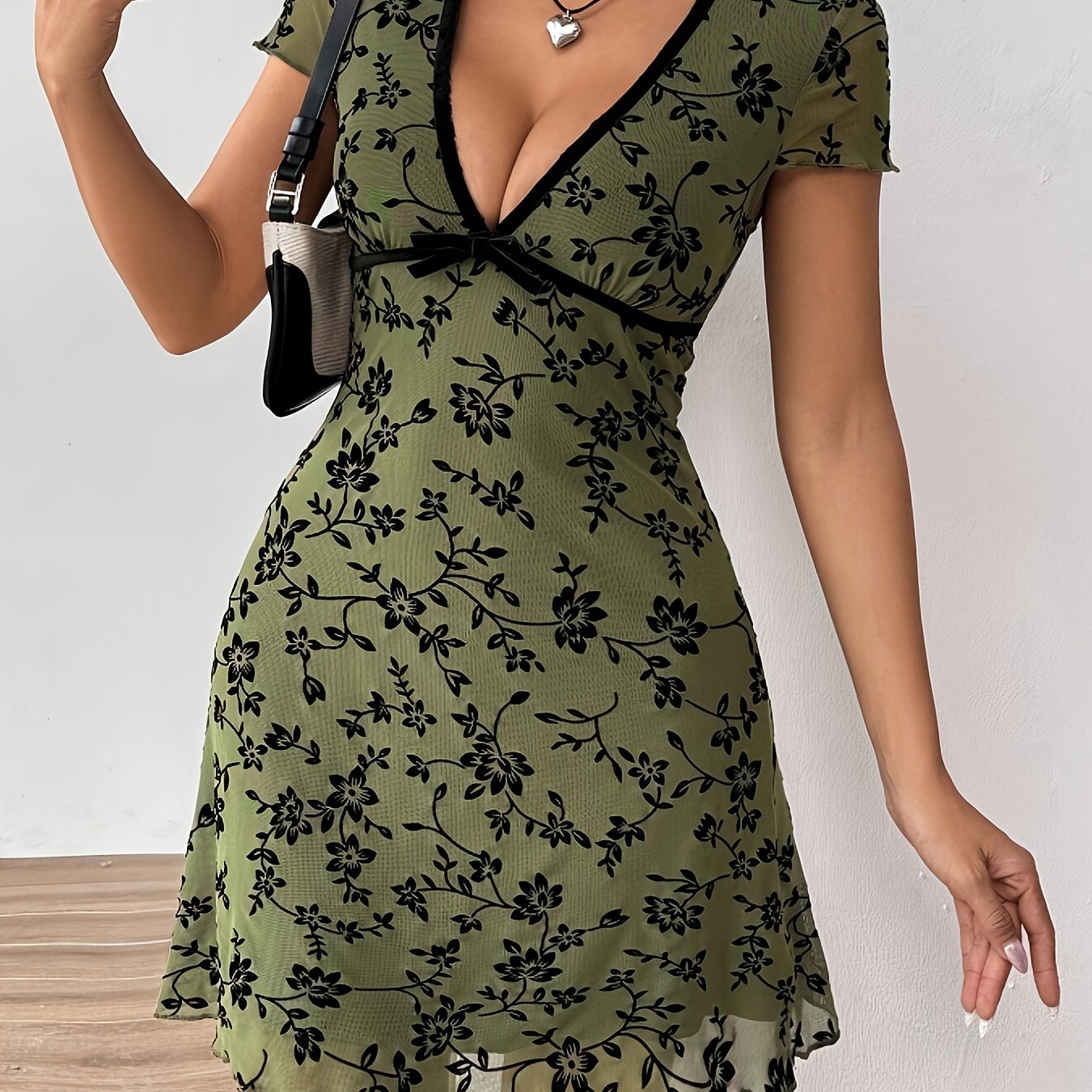 Elegantes Strickkleid mit Blumenmuster, schwarzer Paspelierung und V-Ausschnitt